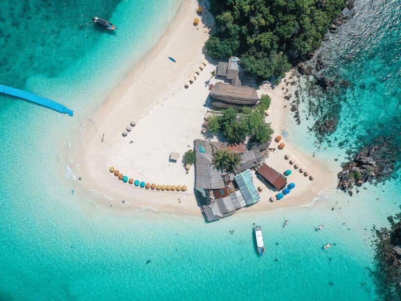 Phuket: 3 Khai Islands Snorkeling Tour - Khai Nok: fish near shore and a busy beach